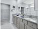 Beautiful bathroom featuring granite countertops, dual sinks, and a walk-in closet at 1580 Delphi Way, New Smyrna Beach, FL 32168
