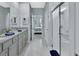 Bright bathroom features a walk-in shower, dual sinks, and an open view into the bedroom at 1580 Delphi Way, New Smyrna Beach, FL 32168