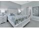 Relaxing bedroom featuring a plush bed with stylish floral bedding and soft, neutral tones at 1580 Delphi Way, New Smyrna Beach, FL 32168