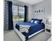 Cozy bedroom with a blue theme featuring coordinated curtains and a quilted bedspread at 1580 Delphi Way, New Smyrna Beach, FL 32168