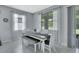 Dining area with modern table, bench seating and abundant natural light from multiple windows at 1580 Delphi Way, New Smyrna Beach, FL 32168