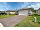 Charming single-story home with an attached garage, well-kept lawn, and manicured landscaping at 1580 Delphi Way, New Smyrna Beach, FL 32168