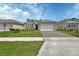 Charming home features a well-manicured lawn and a brick driveway at 1580 Delphi Way, New Smyrna Beach, FL 32168