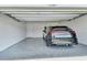 This garage contains a black car and an epoxy floor at 1580 Delphi Way, New Smyrna Beach, FL 32168