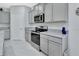 The well-equipped kitchen boasts granite countertops, stainless steel appliances, and ample cabinet space at 1580 Delphi Way, New Smyrna Beach, FL 32168