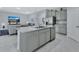 Open-concept kitchen with granite island, stainless steel appliances, and seamless flow to the living area at 1580 Delphi Way, New Smyrna Beach, FL 32168