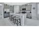 The modern kitchen boasts stainless steel appliances, granite countertops, and a spacious center island with seating at 1580 Delphi Way, New Smyrna Beach, FL 32168