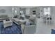 Open-concept living space features modern gray interior design with stainless appliances and a breakfast bar at 1580 Delphi Way, New Smyrna Beach, FL 32168