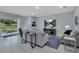 Bright living room with neutral décor, tile floors, and sliding glass doors to outdoor patio at 1580 Delphi Way, New Smyrna Beach, FL 32168