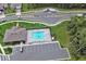 Aerial view of a community pool with lounge chairs, parking, and well-maintained landscaping at 1580 Delphi Way, New Smyrna Beach, FL 32168
