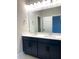 Bathroom featuring double sink vanity with quartz countertop and dark cabinetry at 16454 Silver Brook Way, Winter Garden, FL 34787