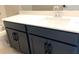 Bathroom features modern vanity with quartz countertop, dark cabinetry and chrome faucet at 16454 Silver Brook Way, Winter Garden, FL 34787