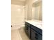 Modern bathroom with tub and shower, quartz countertop and dark cabinetry at 16454 Silver Brook Way, Winter Garden, FL 34787