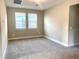 Neutral bedroom with carpet, white trim, and large windows with white blinds providing ample natural light at 16454 Silver Brook Way, Winter Garden, FL 34787