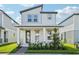 Charming two-story home with modern design, a cozy front porch, and well-manicured landscaping at 16454 Silver Brook Way, Winter Garden, FL 34787