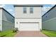 Two-story home with a white garage door, brick driveway, and green lawn at 16454 Silver Brook Way, Winter Garden, FL 34787