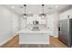Modern kitchen featuring a central island, stainless steel appliances, and stylish pendant lighting at 16454 Silver Brook Way, Winter Garden, FL 34787