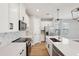 Modern kitchen featuring white cabinets, quartz countertops, stainless steel appliances, and hardwood floors at 16454 Silver Brook Way, Winter Garden, FL 34787