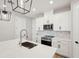 Bright modern kitchen featuring white cabinets, stylish fixtures, and a large island at 16454 Silver Brook Way, Winter Garden, FL 34787