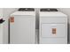 Modern laundry area with white washer and dryer at 16454 Silver Brook Way, Winter Garden, FL 34787