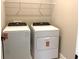 Convenient laundry room with appliances, wire shelving, and plenty of space for folding at 16454 Silver Brook Way, Winter Garden, FL 34787