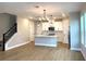Open concept living space featuring hardwood floors and a modern kitchen with stainless steel appliances at 16454 Silver Brook Way, Winter Garden, FL 34787