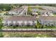 Townhome community near pond, with a white fence and green spaces at 1900 Erudite Way, Winter Park, FL 32792