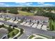 Beautiful aerial view of modern townhomes with garages, landscaping, and a well-maintained street at 1900 Erudite Way, Winter Park, FL 32792