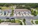 The aerial shot highlights the community's townhomes and streetscape at 1900 Erudite Way, Winter Park, FL 32792