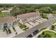 Aerial view of townhomes featuring landscaped lawns and a pond at 1900 Erudite Way, Winter Park, FL 32792
