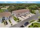 Aerial view of townhomes with green spaces, and near a pond at 1900 Erudite Way, Winter Park, FL 32792