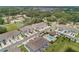 Aerial view showcases townhomes, a community pool, and lush surroundings at 1900 Erudite Way, Winter Park, FL 32792