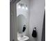 Powder room with a pedestal sink, oval mirror and modern chrome lighting at 1900 Erudite Way, Winter Park, FL 32792