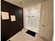 Bathroom features a modern shower with white tile, black accents, and a neutral-toned tile floor at 1900 Erudite Way, Winter Park, FL 32792