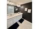Modern bathroom features double vanity with quartz countertop and stylish lighting fixtures at 1900 Erudite Way, Winter Park, FL 32792