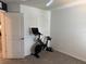 Bedroom space with a stationary bike, ideal for fitness enthusiasts, with neutral colored carpet at 1900 Erudite Way, Winter Park, FL 32792