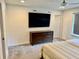 Bright bedroom features ceiling fan, large TV, and stylish dark wood dresser at 1900 Erudite Way, Winter Park, FL 32792