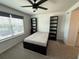 Bright bedroom featuring modern ceiling fan, window and built in bookcases at 1900 Erudite Way, Winter Park, FL 32792