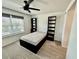 Bright bedroom featuring modern ceiling fan, window and built in bookcases at 1900 Erudite Way, Winter Park, FL 32792