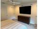 Bright bedroom features ceiling fan, large TV, and stylish dark wood dresser at 1900 Erudite Way, Winter Park, FL 32792