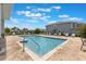 Community pool with inviting lounge chairs and well-kept landscaping at 1900 Erudite Way, Winter Park, FL 32792