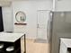 Entryway showing coat closet, stainless refrigerator, and accent mirror on the wall at 1900 Erudite Way, Winter Park, FL 32792