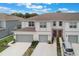 Well-maintained townhome featuring a two-car garage and pristine landscaping, perfect for comfortable living at 1900 Erudite Way, Winter Park, FL 32792