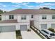 Charming townhome featuring a two-car garage and pristine landscaping, perfect for modern living at 1900 Erudite Way, Winter Park, FL 32792