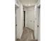 Hallway with neutral carpet and white doors that provide a calm and inviting transitional space at 1900 Erudite Way, Winter Park, FL 32792