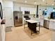 Bright kitchen featuring white cabinetry, stainless steel appliances, a center island, and modern pendant lighting at 1900 Erudite Way, Winter Park, FL 32792