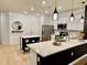 Bright kitchen showcasing a quartz countertop island with modern pendant lighting and stainless appliances at 1900 Erudite Way, Winter Park, FL 32792