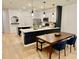 Charming kitchen featuring a large island with quartz countertops, modern appliances, and a dining table with seating at 1900 Erudite Way, Winter Park, FL 32792