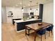 Modern kitchen featuring white cabinets, stainless steel appliances, and an island with quartz countertop at 1900 Erudite Way, Winter Park, FL 32792