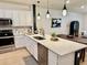 Bright kitchen featuring white cabinetry, stainless steel appliances, a center island, and modern pendant lighting at 1900 Erudite Way, Winter Park, FL 32792